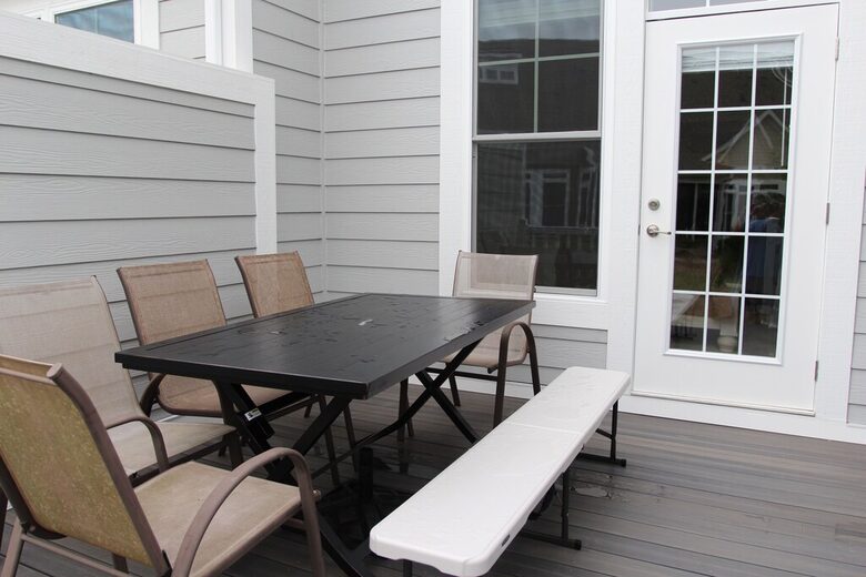 Deck area with gas grill off of screened in porch and primary bedroom