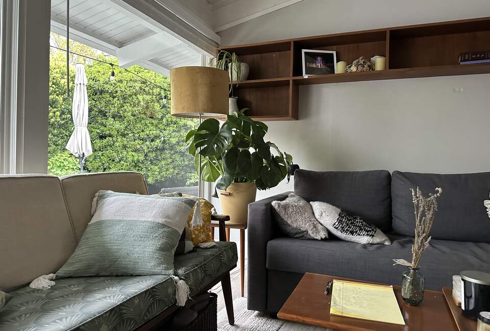 Livingroom with double couches. One pulls out to a queen bed