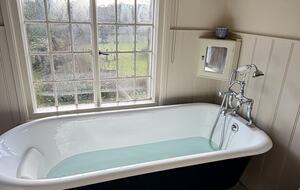 Enjoy a bath with a stunning rural view in upstairs bathroom.