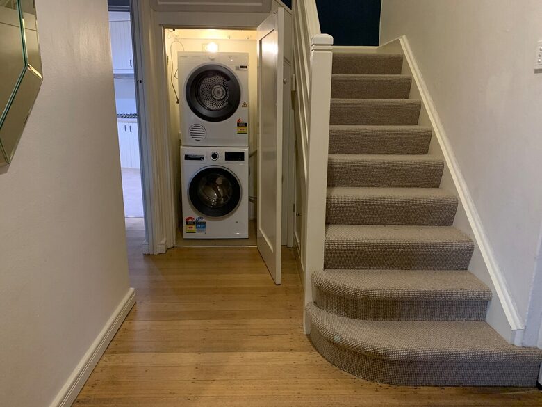 Washing machine and dryer located under the stairs