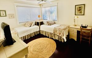 third bedroom with two twin beds and a desk