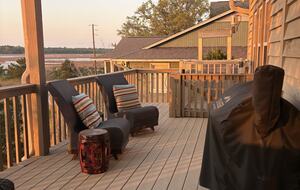 Main level balcony with seating, grill, and lift