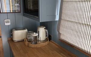 Mini kitchen with fridge and microwave in the Shepherds Hut