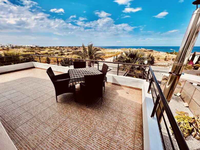 master bedroom balcony view and dining table and chairs
