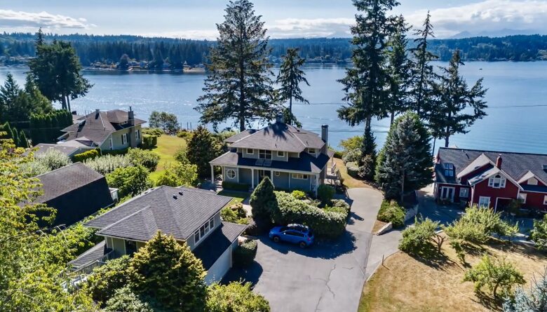 View of property with bay and Olympic Mountains
