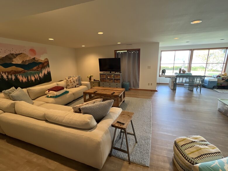 Lower level TV area leads out to large lawn