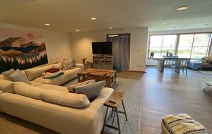 Lower level TV area leads out to large lawn
