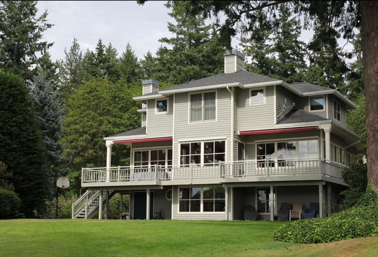 View of home and bay view decks from lawn area