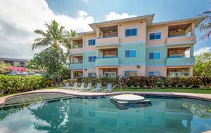 Beach condo exterior with pool and spa