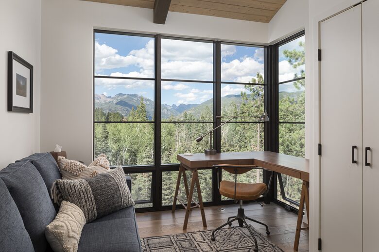 Private reading room with desk, sofa, and mountain views.