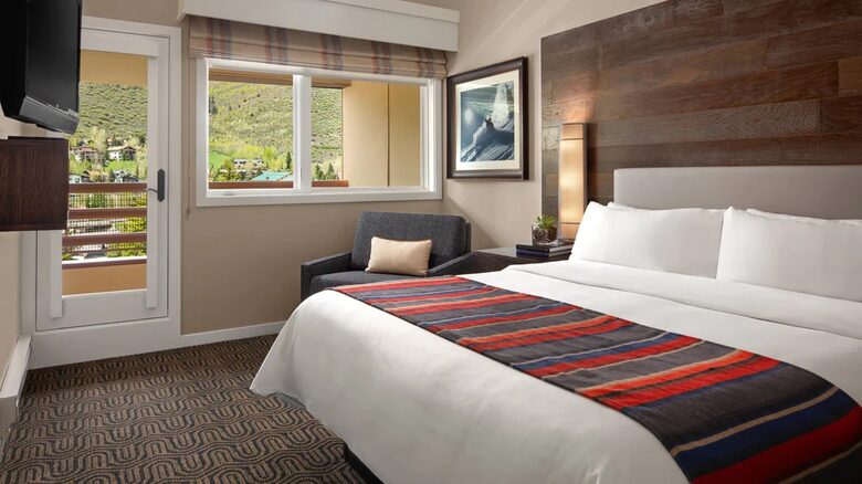 Master bedroom with balcony and mountain views