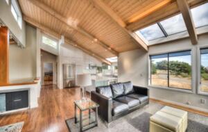 Open living and dining rooms with vaulted ceilings