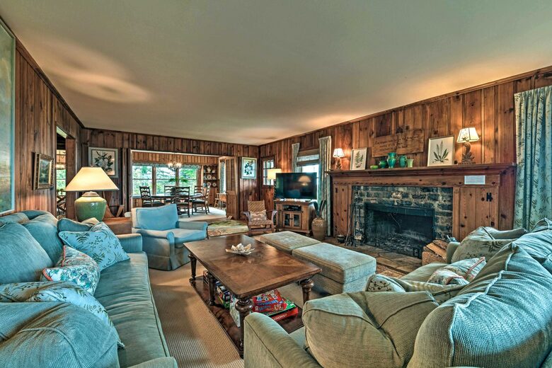 Main living room with stone fireplace and smart TV
