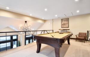 Loft with large sofa and pool table