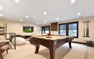 Loft with large sofa and pool table