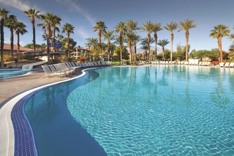 Home Exchange in Pam Desert, CA resort pool under the palms