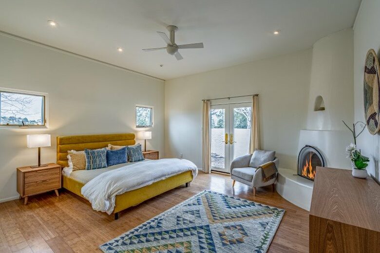 Master bedroom with fireplace and private patio