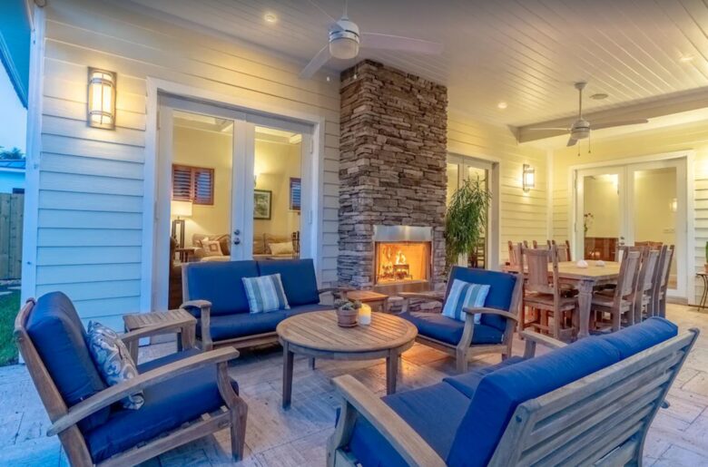 Outdoor living with fireplace and dining table for eight