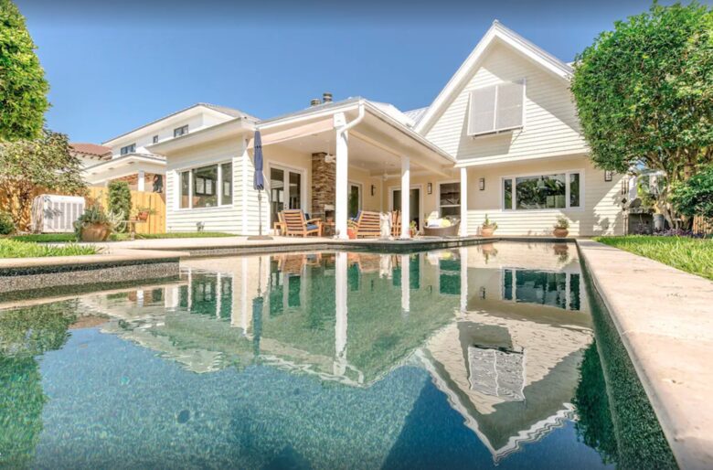 private pool with private outdoor shower on side of house