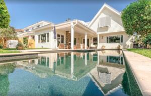 private pool with private outdoor shower on side of house