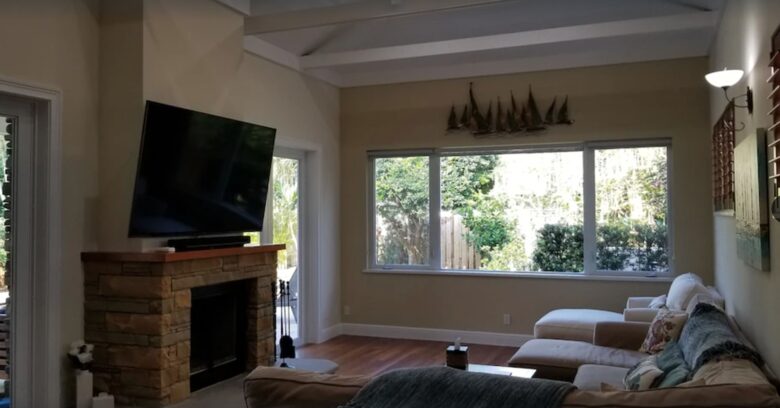Living room with 75 inch TV over fireplace
