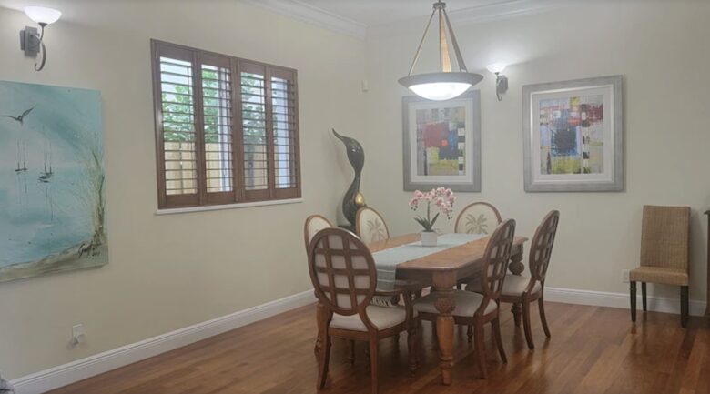 Dining table in great room with full view to kitchen