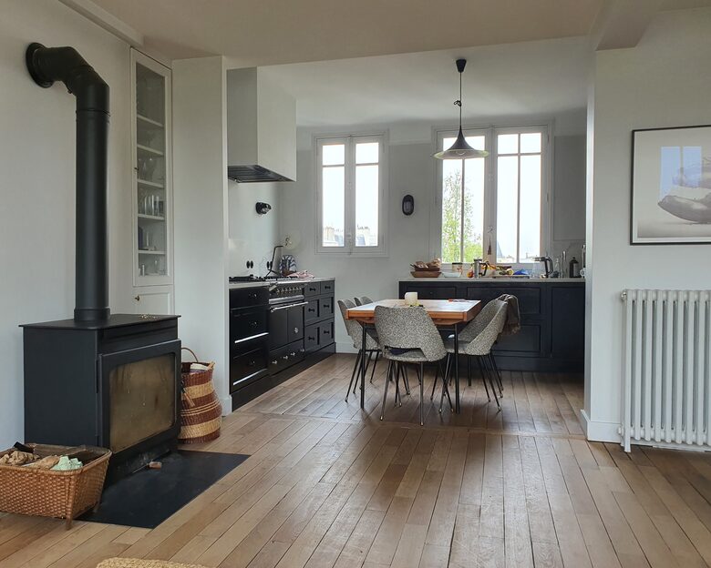 view from the living room into the kitchen, with fire place