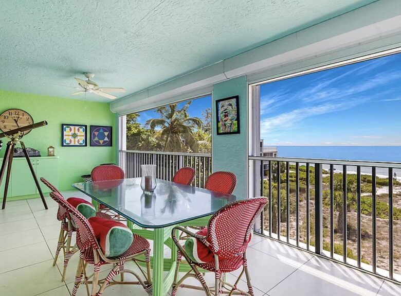 Balcony with two dinning tables and unobstructed views of gulf