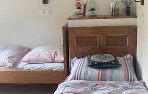 Another large upstairs room, with 2 single beds and 1 double