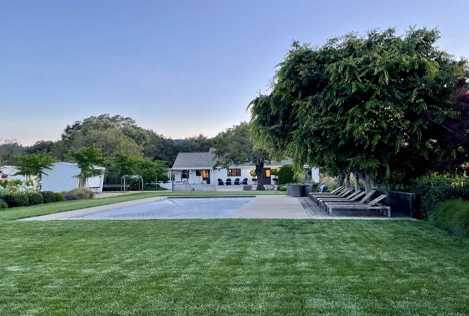 View of home from garden at dusk