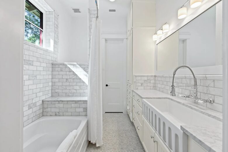 Bunk room tub/shower with farm sink for infants