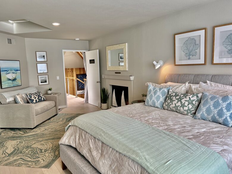 CA king bed. Lighter bedding is used during warmer months.