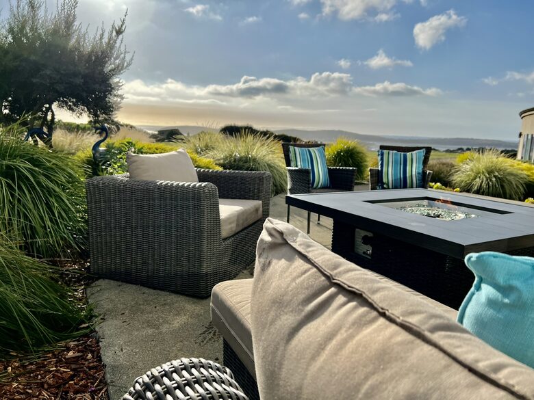 Fire pit table with fairway and ocean views beyond.