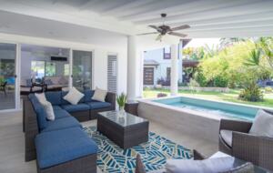 Private patio with lounge chairs and dining