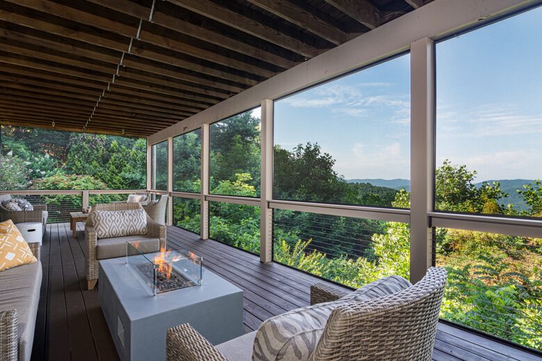 Downstairs screened in deck with firepit and amble seating