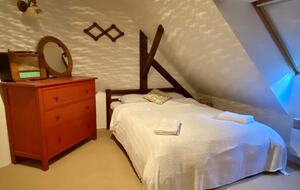 Double bedroom, with two single beds on other side of room