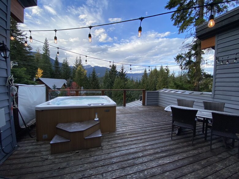 Private deck with hot tub and outdoor dining area