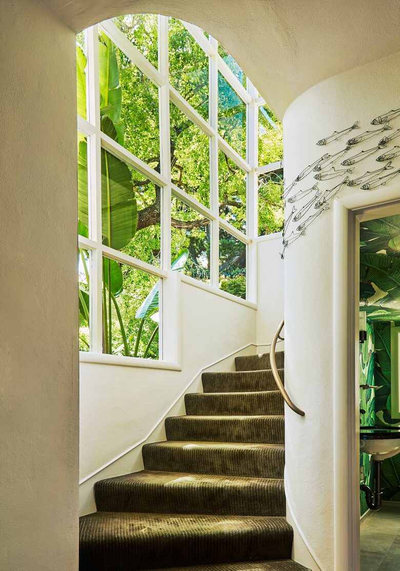 stairway 2nd floor to 3rd floor with glimpse of 1/2 bath