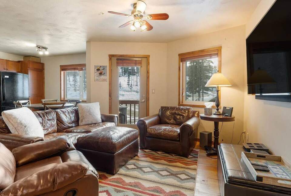 Living room/ kitchen area with small patio and BBQ