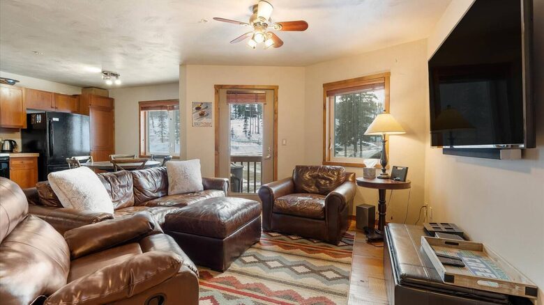 Living room/ kitchen area with small patio and BBQ