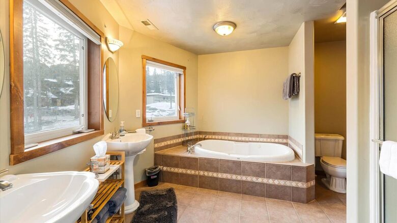 Master bedroom bathroom includes two sinks, a shower and a bathtub
