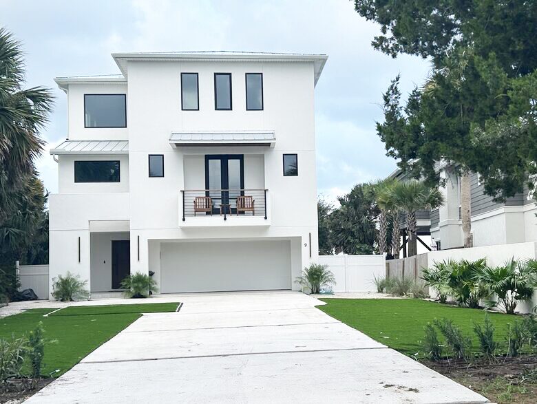 Street view of 2 car garage, and west facing bedroom deck