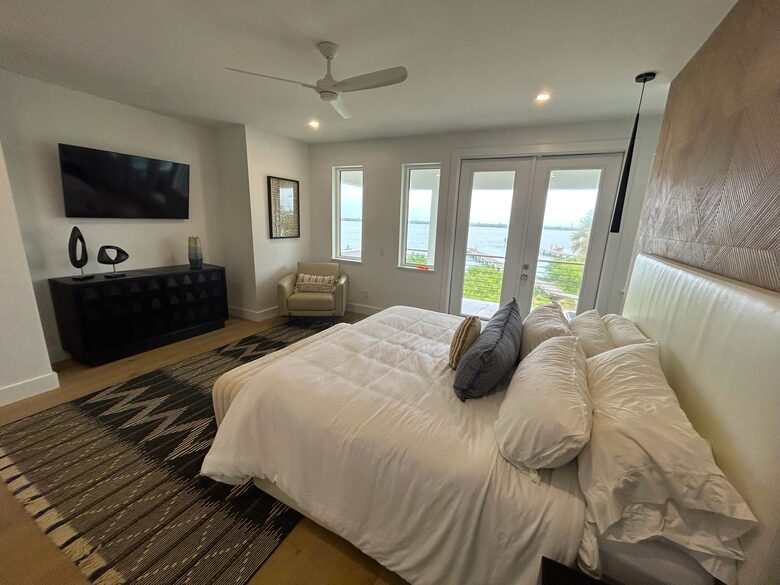 Primary Bedroom with 55" TV, private covered deck & hot tub