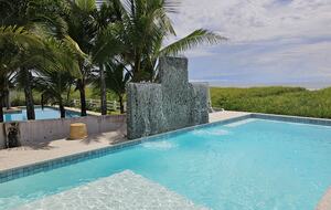The focal point of the outdoor space is the large ocean-front pool