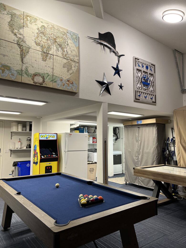 Pool table, air hockey table and PAC-Man arcade game.