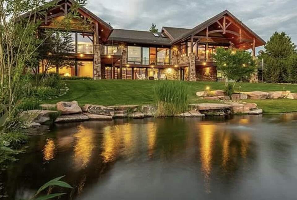 Back of the home that looks toward the mountains, with pond.
