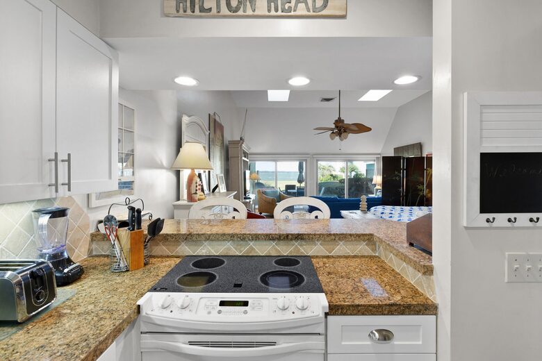 Kitchen opens to living area and water views