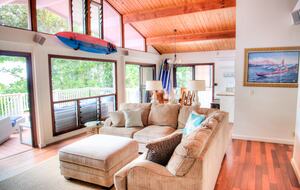 Living Room overlooking outdoor deck, beach, ocean and sunset