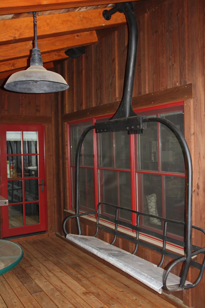 Covered porch off kitchen with BBQ and ski chair seat