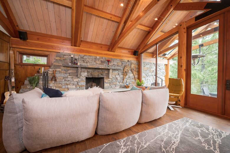 Down filled couch for apres ski lounging, with rock fireplace